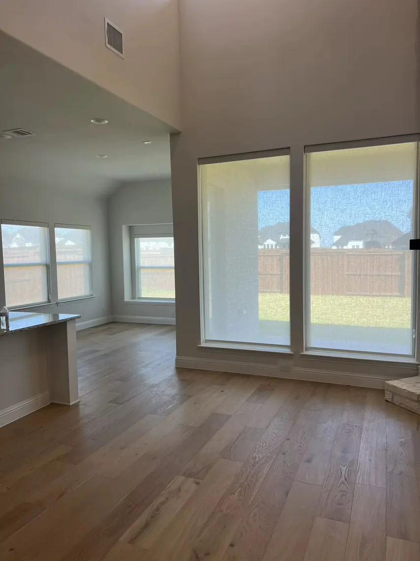 Solar shades in a bright open living room
